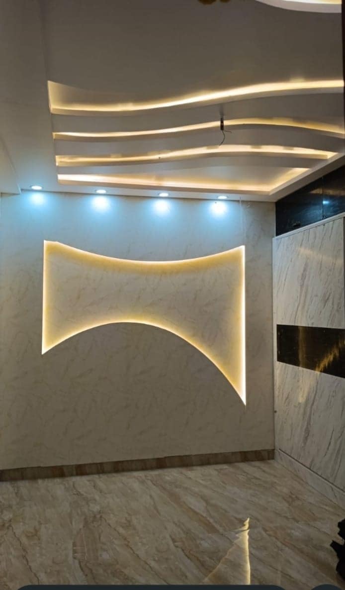 False ceiling with concealed cove lighting above a marble-finished wall in a Visakhapatnam home