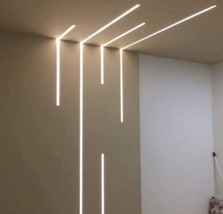 Ceiling detail with recessed linear LED strips in a Visakhapatnam interior